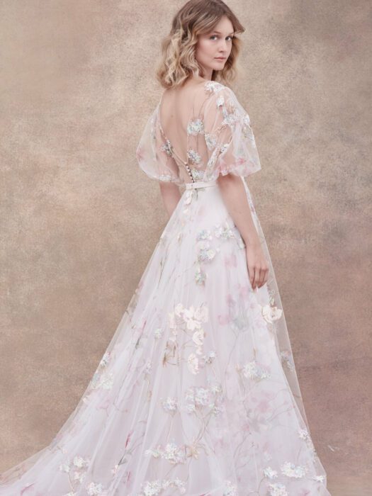 Image of bride wearing flowing, dreamlike dress with floral design and open back from Dream by Savin Wedding Dress Collection